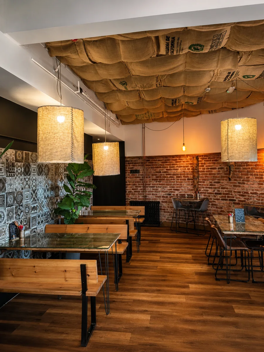 North Beach Coffee Bar dining room with pendant lights and brick walls