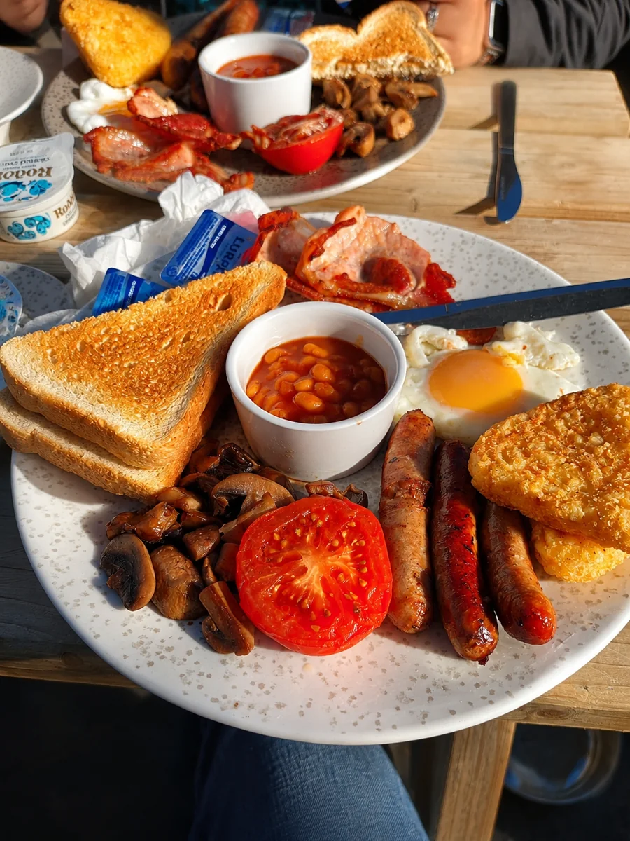 Cooked breakfast with eggs, sausages, bacon, beans and toast