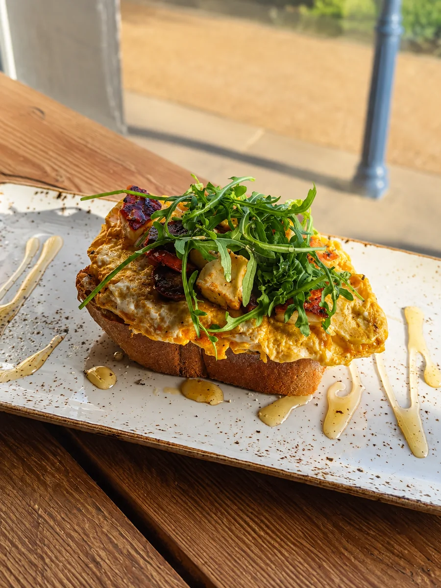 Sourdough brunch toast with eggs and greens at North Beach Coffee Bar